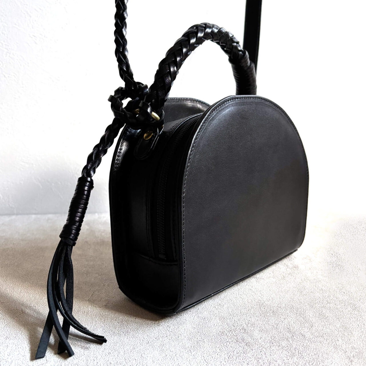 Leather bag with braided leather handles